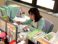対馬釜山事務所の机でパソコン業務を行う女性の写真